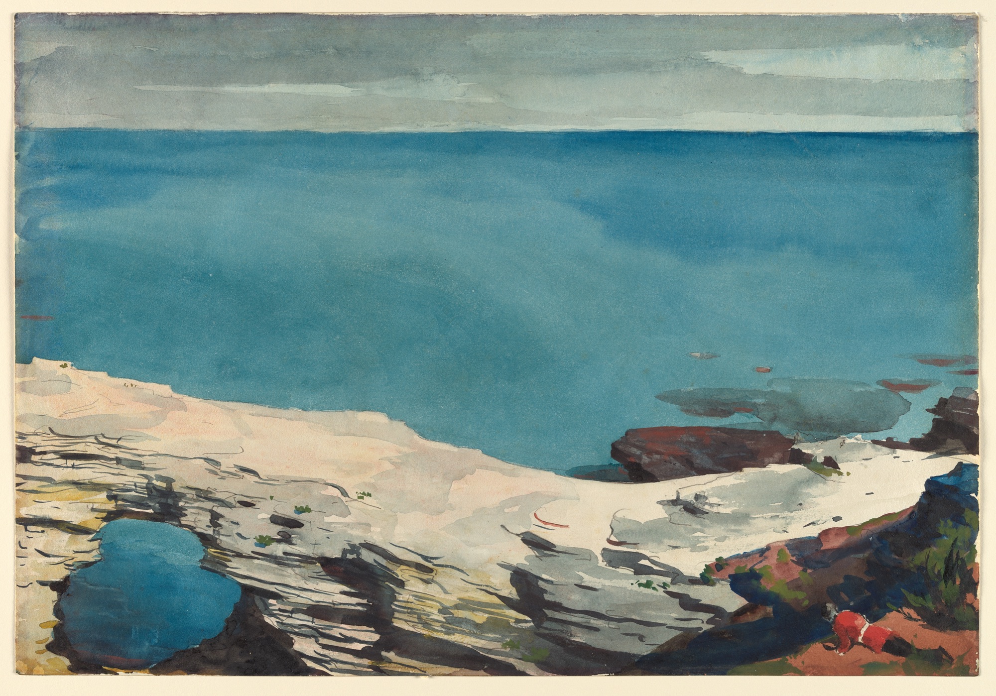 A flat expanse of turquoise sea fills the frame above a pale coral limestone arch, with a small tide pool caught in the rocks and a tiny figure in red at the lower right